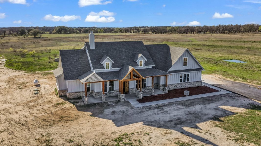 Front exterior of a new home in Oak Water Ranch, Granbury, TX, highlighting curb appeal (Image 16).