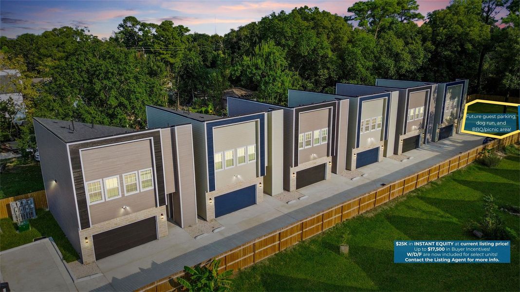 From above, you can see the striking row of modern townhomes, each with bold architectural lines and stylish exteriors. The clean, uniform design makes the community feel contemporary and cohesive, while the private fenced backdrop ensures both privacy and peace.