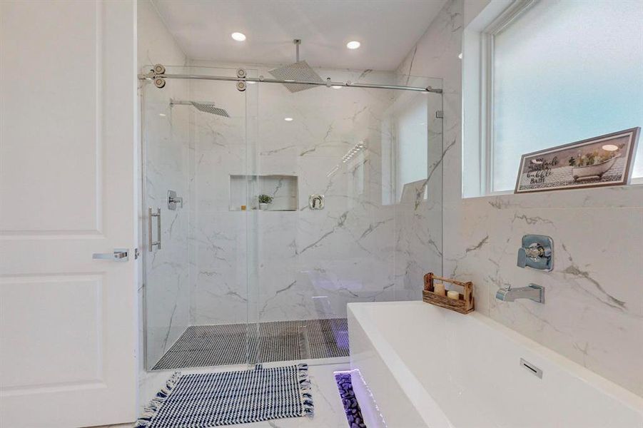 Bathroom with tile walls and separate shower and tub