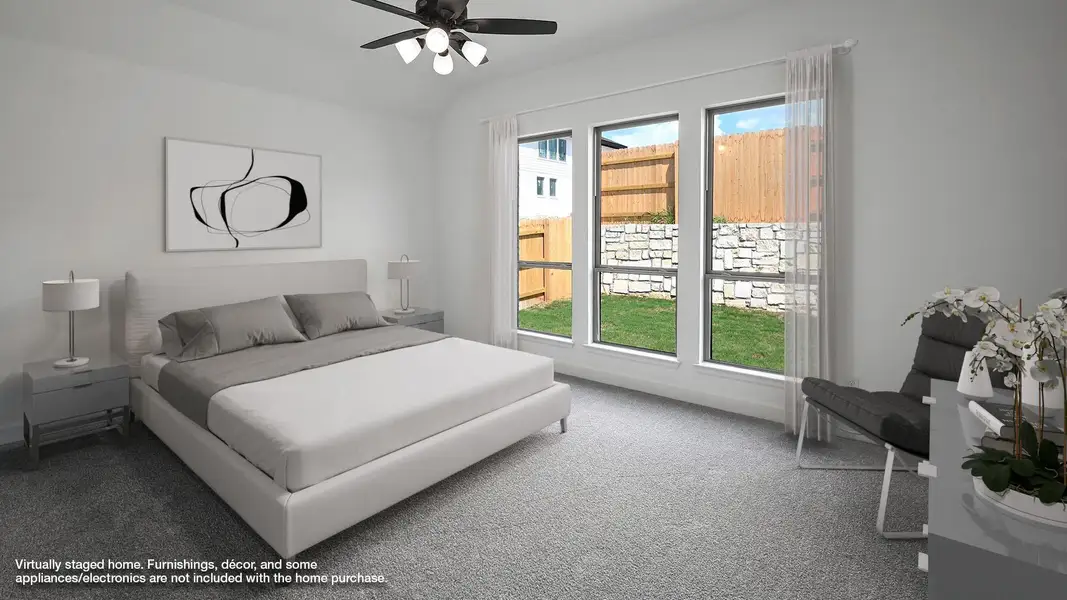 Bedroom with carpet, a ceiling fan, and lofted ceiling Bedroom with carpet, a ceiling fan, and lofted ceiling