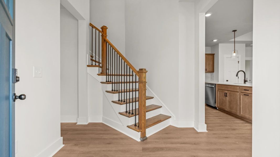 Exceptional foyer with warm hardwood flooring and refined finishes throughout
