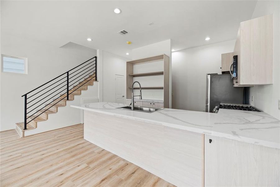 The Kitchen space offers lots of cabinet storage and designer built-ins.