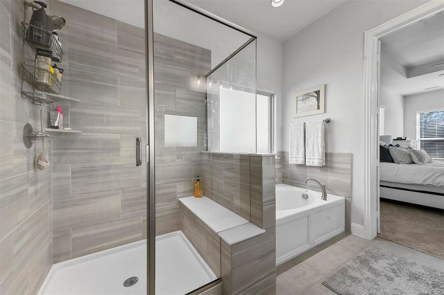 Bathroom with tile patterned flooring and separate shower and tub