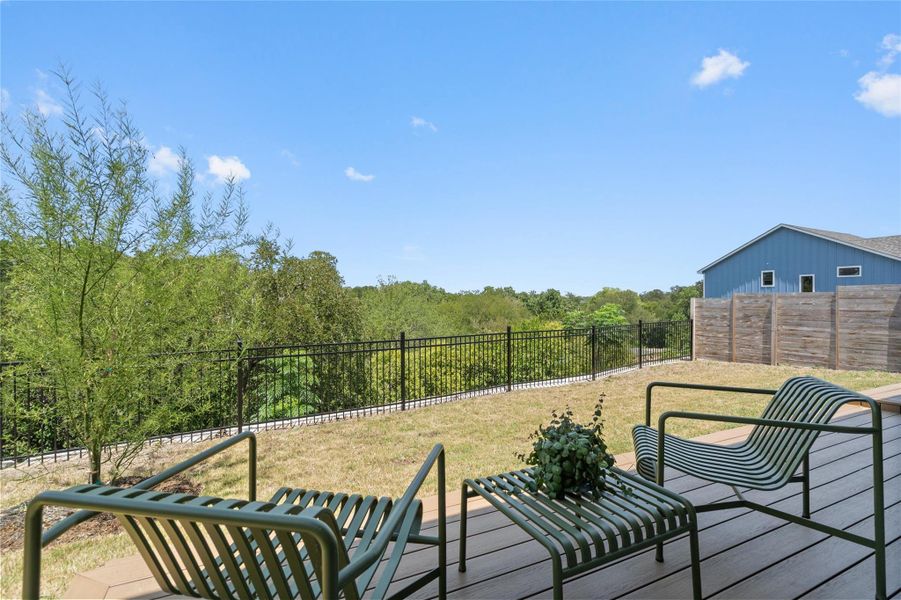 A raised wooden deck offers comfortable seating and views of a verdant landscape under an open sky. A raised wooden deck offers comfortable seating and views of a verdant landscape under an open sky.