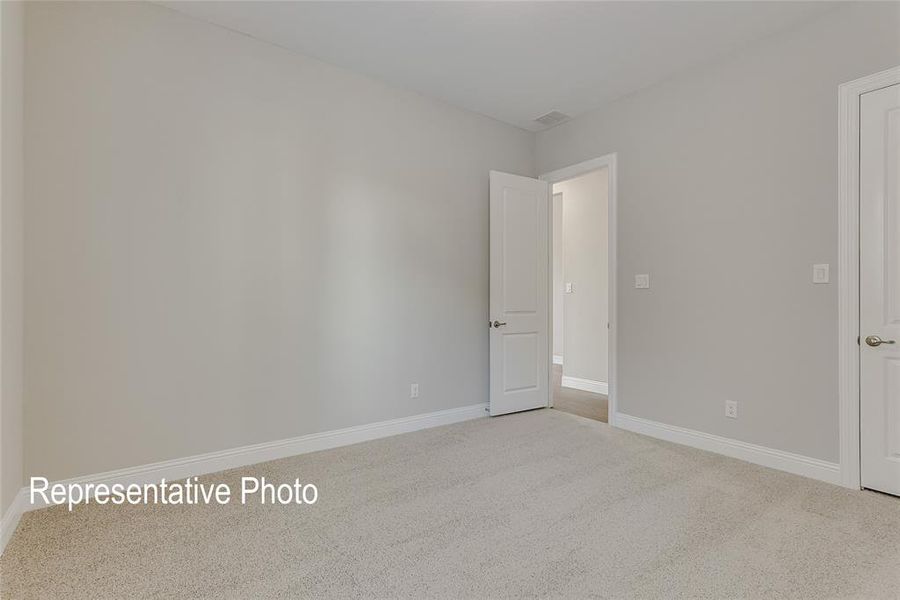 Wall-to-wall carpeting with light gray walls, white baseboards, and white interior doors