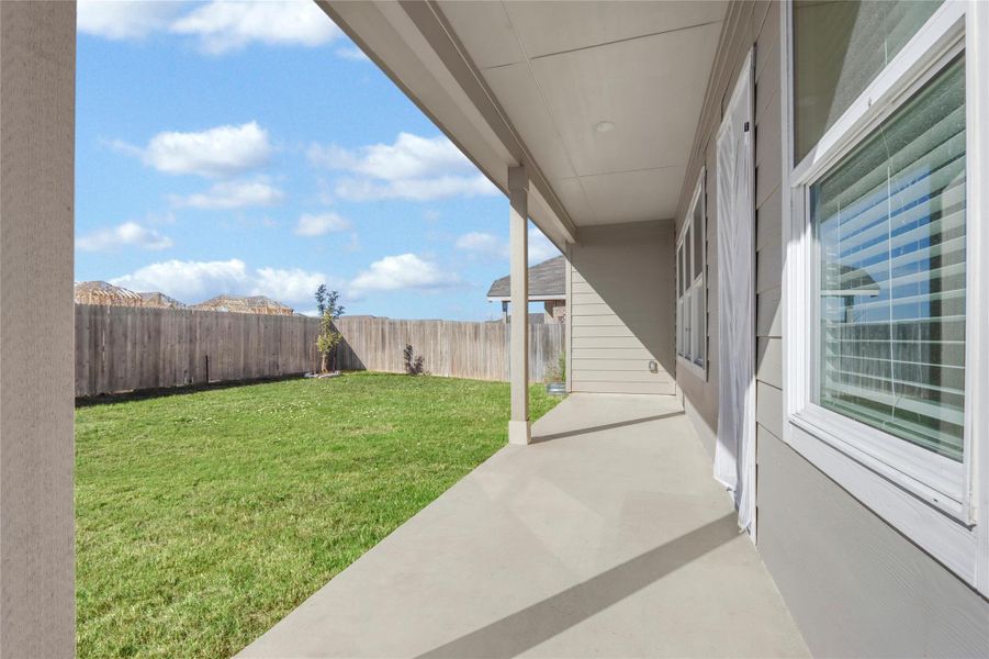 Fenced backyard featuring a patio