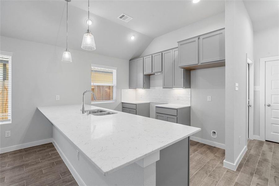 Any chef's dream, this stunning kitchen is perfect for everyday life as well as entertaining family and friends! Extra large kitchen peninsula is perfect for conversation or that much needed space to lay out your party spread for everyone to enjoy! Large windows provide plenty of natural lighting throughout the day.