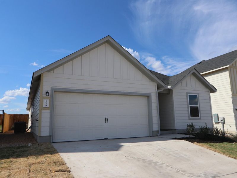 Front exterior of a new home in Cascades at Onion Creek, Austin, TX, highlighting curb appeal (Image 1). Front exterior of a new home in Cascades at Onion Creek, Austin, TX, highlighting curb appeal (Image 1).