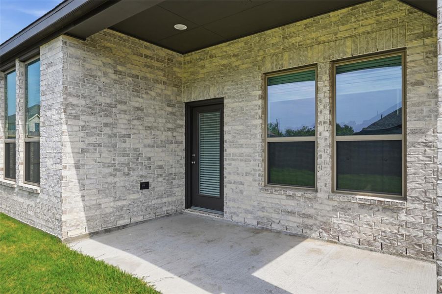 Charming covered patio with stylish brickwork, perfect for outdoor relaxation and entertaining.