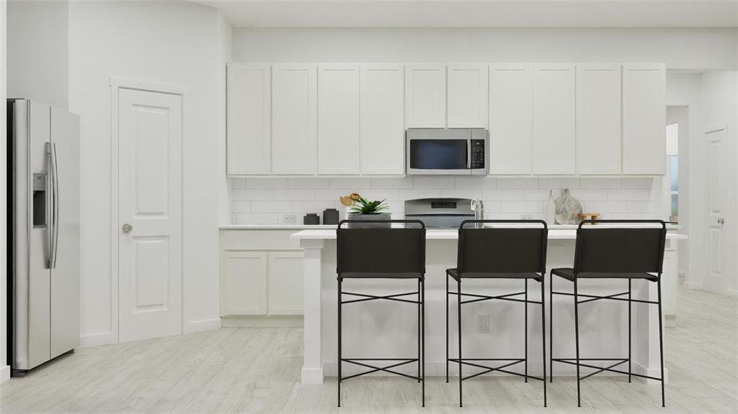 Kitchen featuring backsplash, appliances with stainless steel finishes, a kitchen island with sink, a kitchen breakfast bar, and white cabinetry Kitchen featuring backsplash, appliances with stainless steel finishes, a kitchen island with sink, a kitchen breakfast bar, and white cabinetry