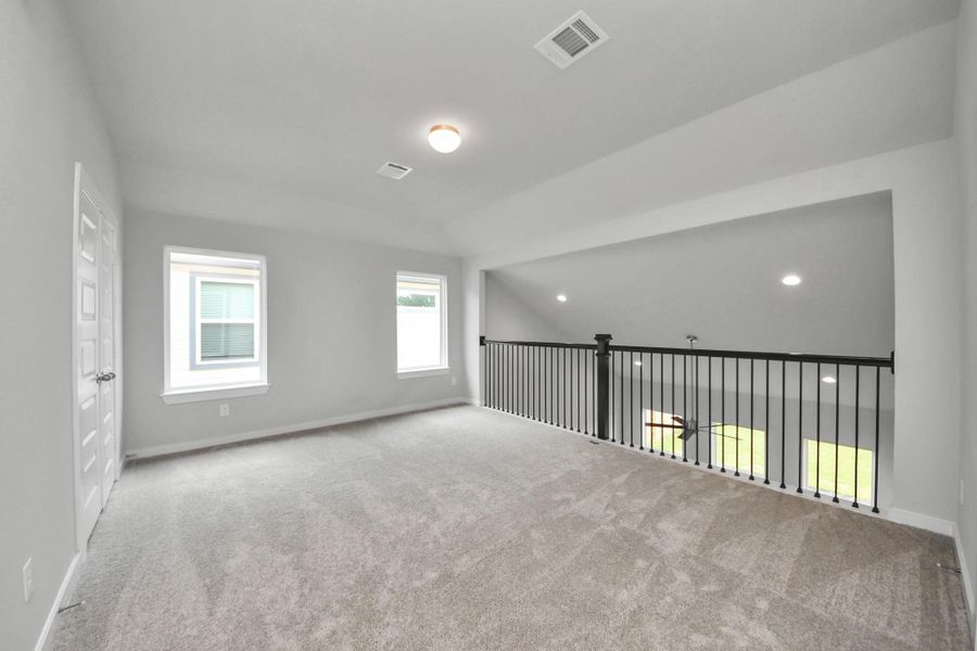 Come upstairs and enjoy a day of leisure in this fabulous game room! This is the perfect hangout spot or adult game room! Features plush carpet, high ceilings, custom paint and windows for plenty of natural light. Come upstairs and enjoy a day of leisure in this fabulous game room! This is the perfect hangout spot or adult game room! Features plush carpet, high ceilings, custom paint and windows for plenty of natural light.