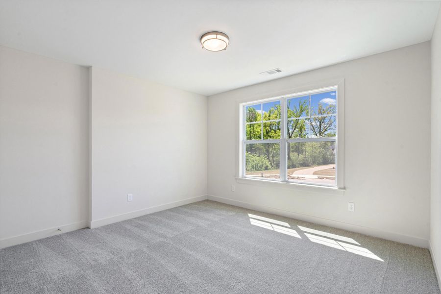 Unfurnished room with light carpet and baseboards