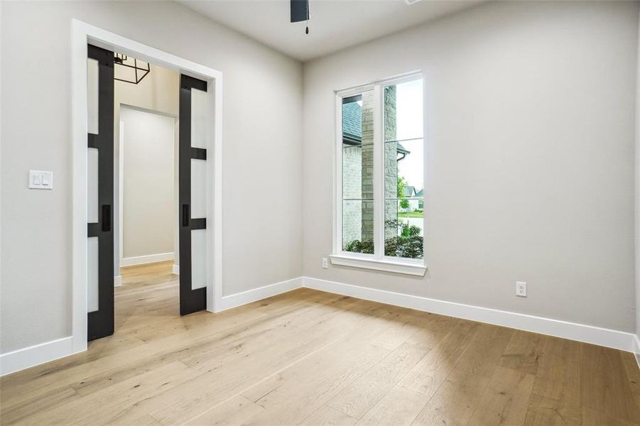 Home office has ceiling fan, led can lights and sliding doors for privacy. Home office has ceiling fan, led can lights and sliding doors for privacy.