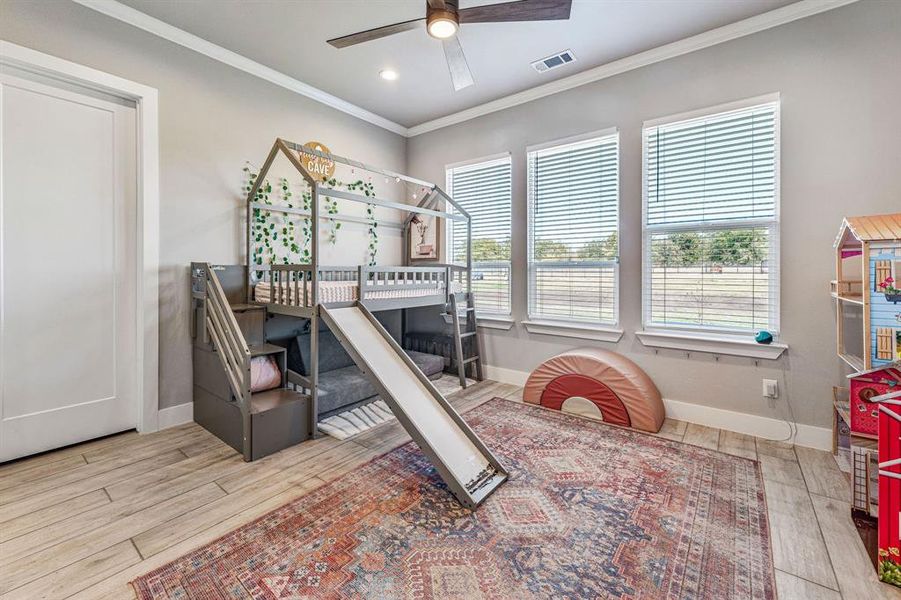 Bedroom featuring ornamental molding, light wood-type flooring, ceiling fan, and recessed lighting