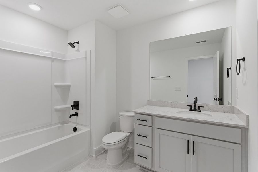 A bathroom with a tub toilet and sink.