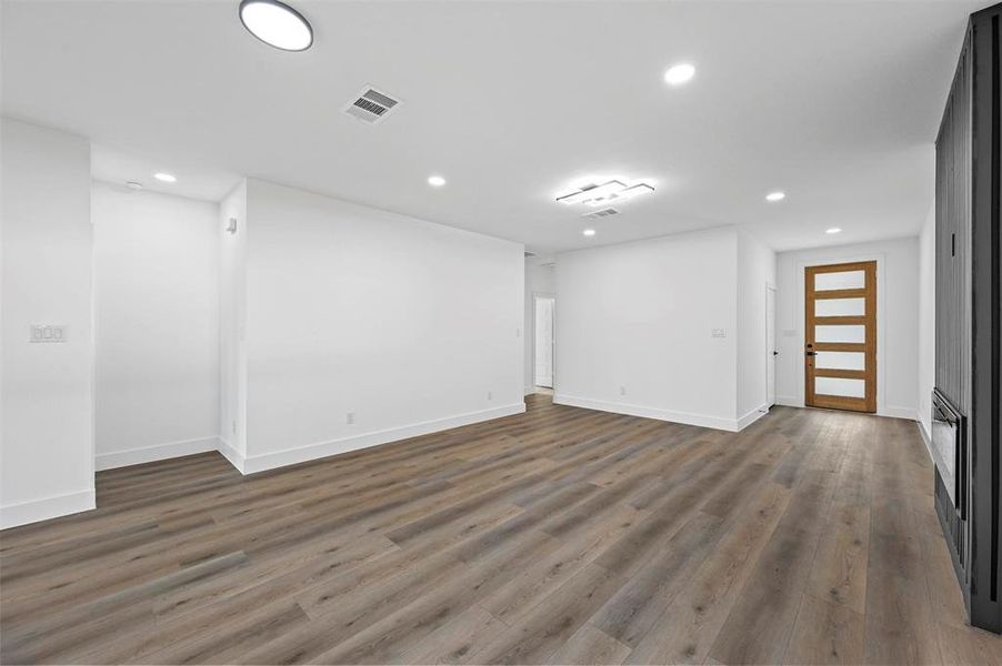 Unfurnished living room featuring wood-type flooring