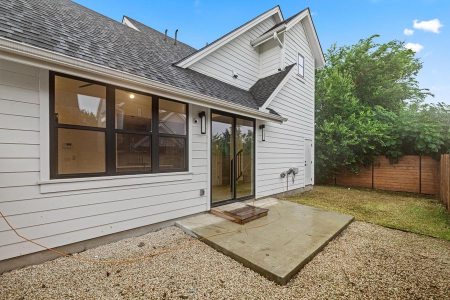 Rear view of property featuring a shingled roof and a patio Rear view of property featuring a shingled roof and a patio