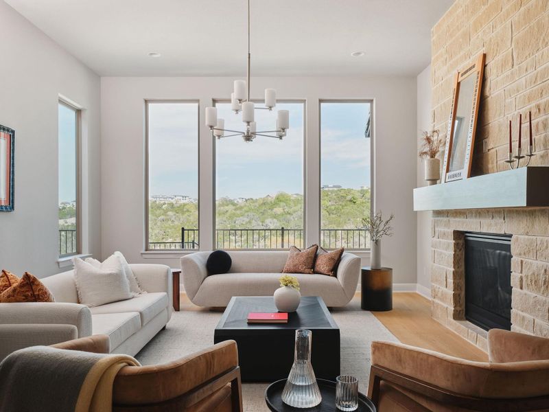 The living room is found adjacent to the kitchen, surrounded by panoramic windows.