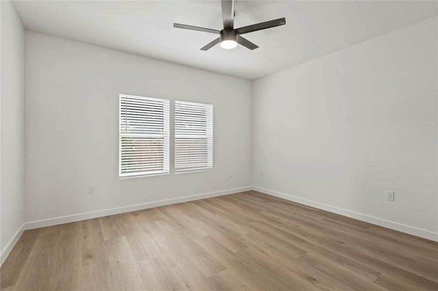 Unfurnished room featuring light wood-style floors and ceiling fan Unfurnished room featuring light wood-style floors and ceiling fan