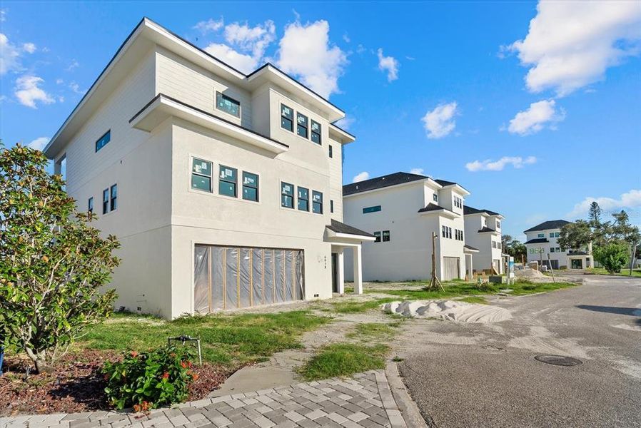 Front exterior of a new home in , Sarasota, FL, highlighting curb appeal (Image 12).