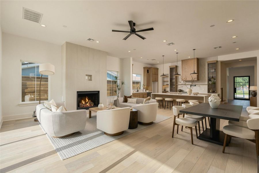 From this perspective, the home’s open-concept design comes fully into view, connecting the living, dining, and kitchen areas into one expansive setting designed for everyday life and larger gatherings alike.