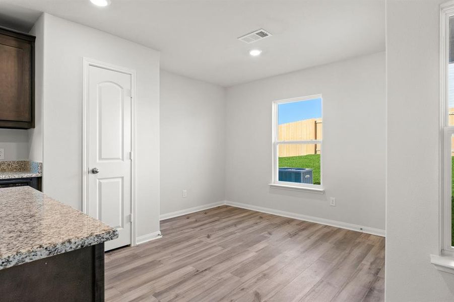 Unfurnished dining area featuring light hardwood / wood-style flooring