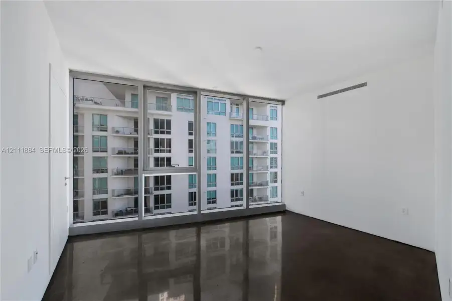 Floor-to-ceiling windows with metal framing and polished concrete flooring Floor-to-ceiling windows with metal framing and polished concrete flooring
