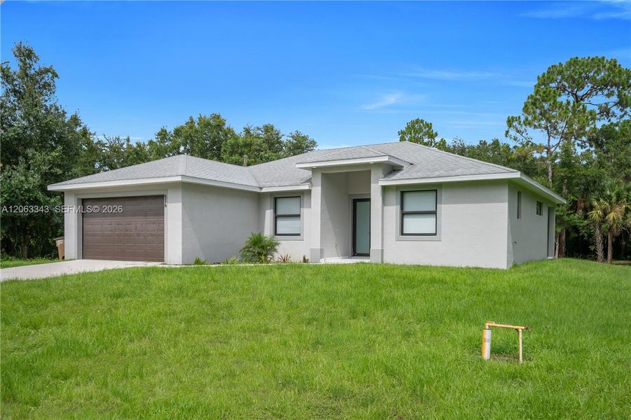 Front exterior of a new home in , Lehigh Acres, FL, highlighting curb appeal (Image 18). Front exterior of a new home in , Lehigh Acres, FL, highlighting curb appeal (Image 18).