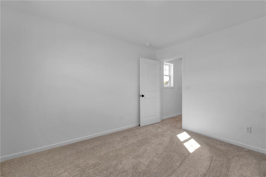 This bright bedroom offers a neutral canvas, ready