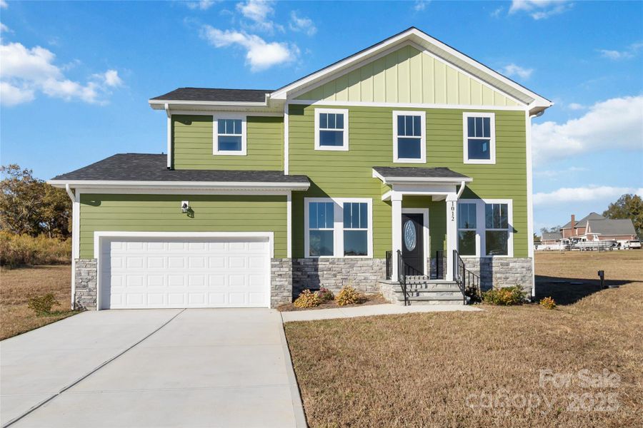 Front exterior of a new home in , Monroe, NC, highlighting curb appeal (Image 1).