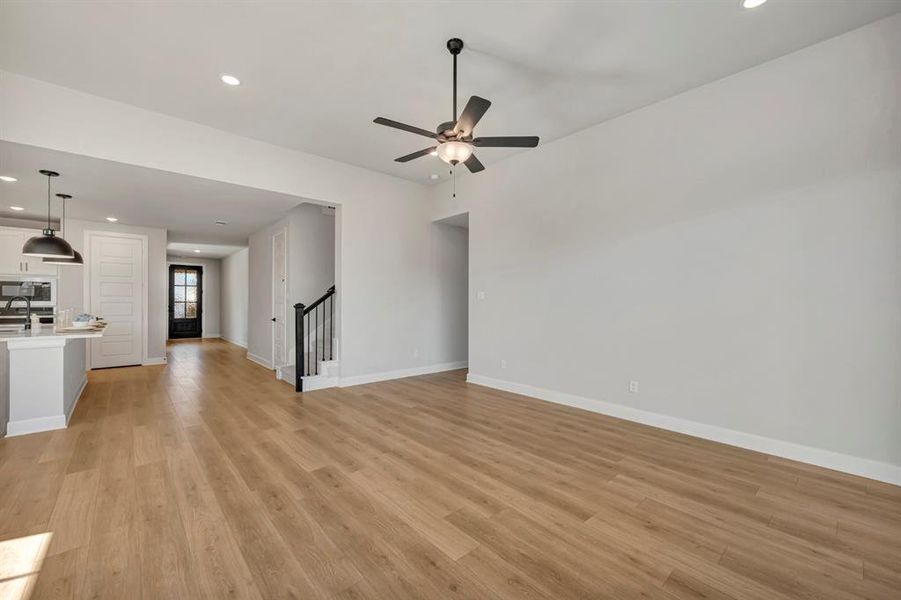 Unfurnished living room featuring recessed lighting, light wood-style floors, and a ceiling fan