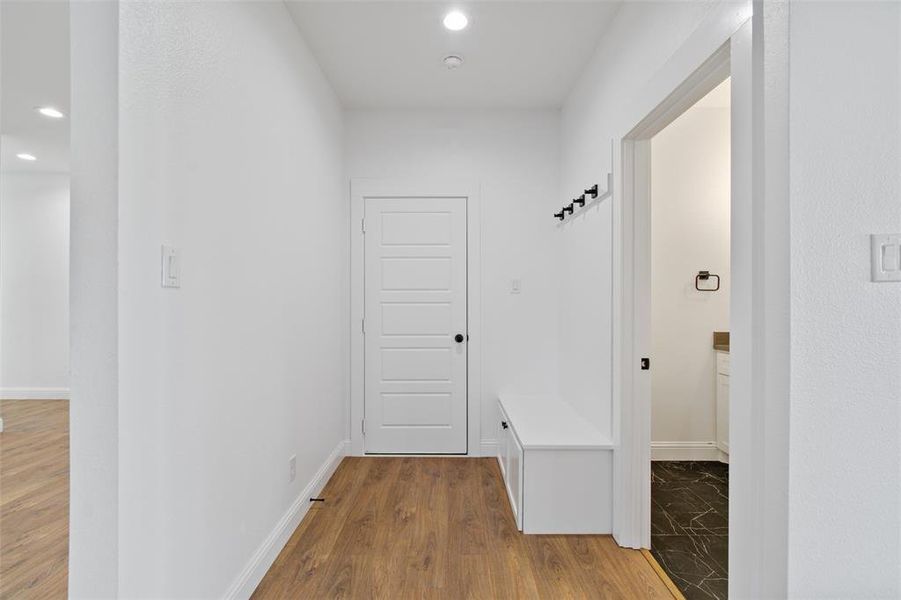 Mudroom with light hardwood / wood-style floors