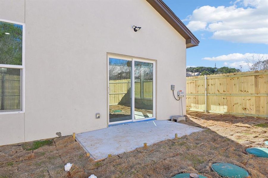 View of patio featuring fence