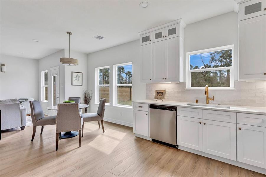 Enjoy abundant natural light flowing from the kitchen to the dining area, complete with a modern dishwasher.