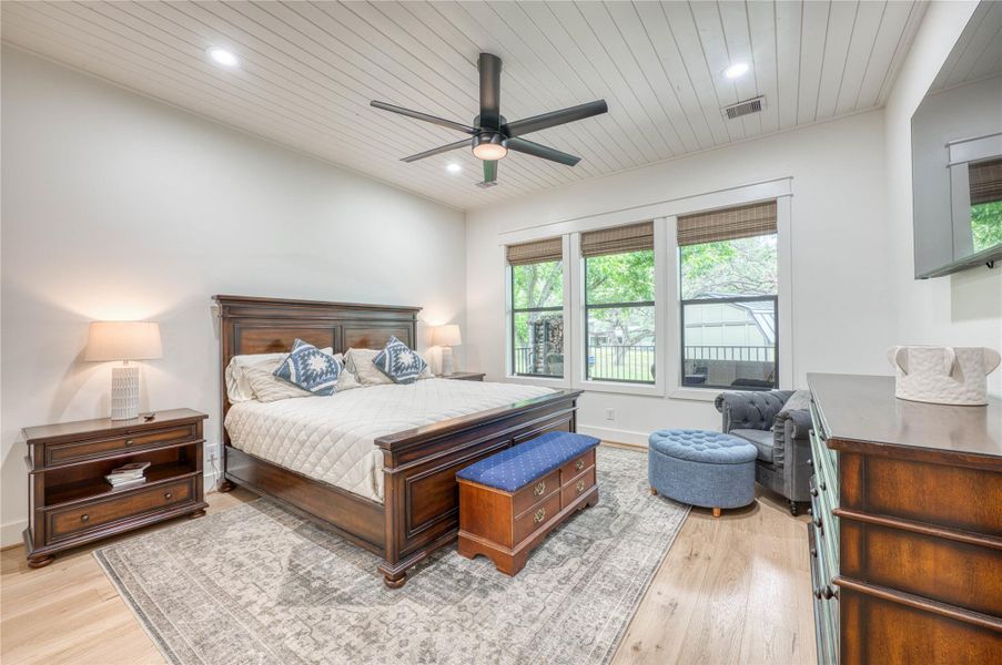 White shiplap ceiling with recessed lighting and a ceiling fan