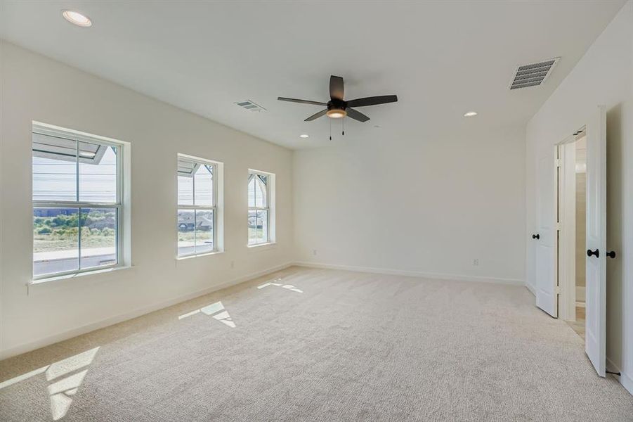 Spare room with light colored carpet, recessed lighting, and a ceiling fan Spare room with light colored carpet, recessed lighting, and a ceiling fan