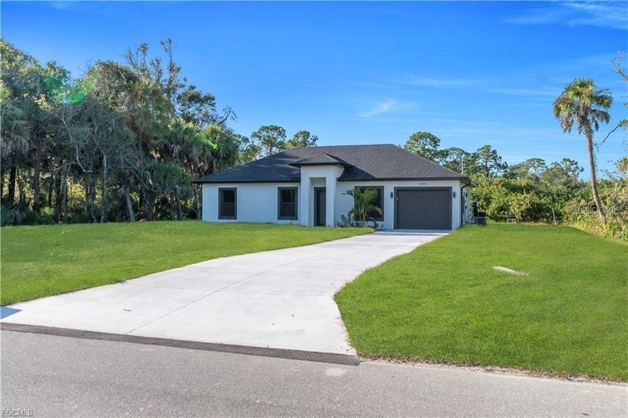 Front exterior of a new home in , Lehigh Acres, FL, highlighting curb appeal (Image 22).
