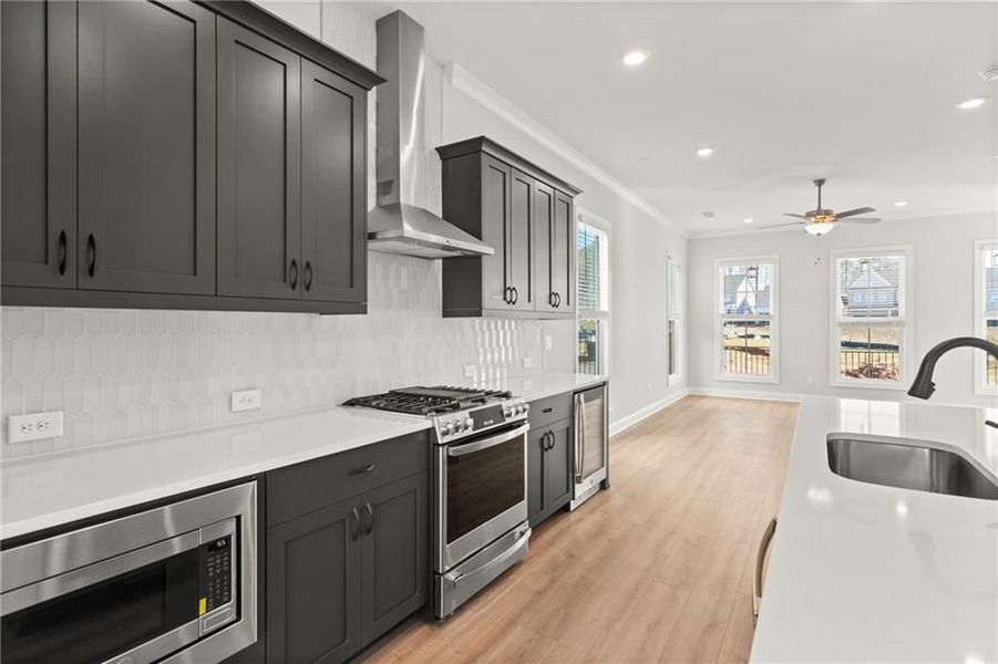 The spacious kitchen is a standout feature, designed with the home chef in mind. It includes high-end stainless steel appliances, sleek countertops, ample cabinetry for storage, and a large center island that serves as the perfect spot for casual dining