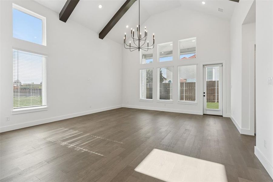 A wall of windows floods this spacious family room with natural light. A wall of windows floods this spacious family room with natural light.