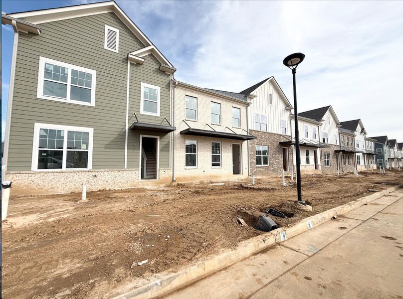 Traditional home featuring a residential view, brick siding, and board and batten siding