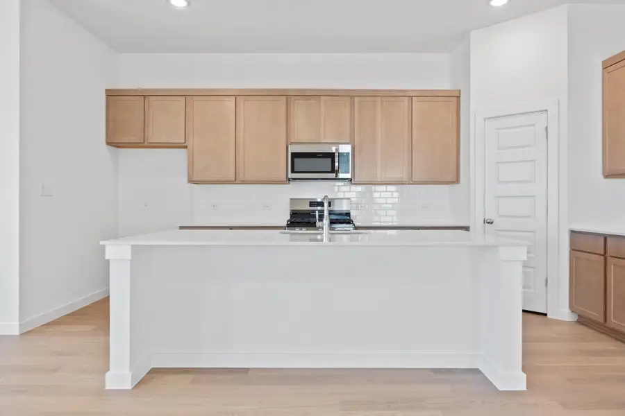 Kitchen in the Quartz home plan by Trophy Signature Homes – REPRESENTATIVE PHOTO