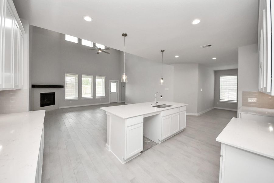 All of this overlooks your expansive family room, creating a perfect space for culinary delights and family gatherings. Sample photo of completed home with similar floor plan. Actual colors and selections may vary. All of this overlooks your expansive family room, creating a perfect space for culinary delights and family gatherings. Sample photo of completed home with similar floor plan. Actual colors and selections may vary.