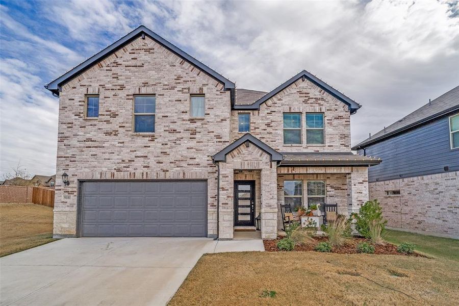View of front facade featuring brick siding, concrete driveway, and a garage View of front facade featuring brick siding, concrete driveway, and a garage