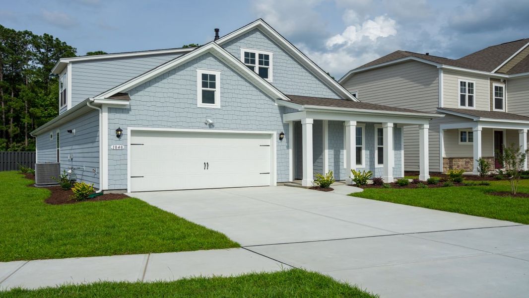 Front exterior of a new home in Surfside Landing, Hubert, NC, highlighting curb appeal (Image 1).