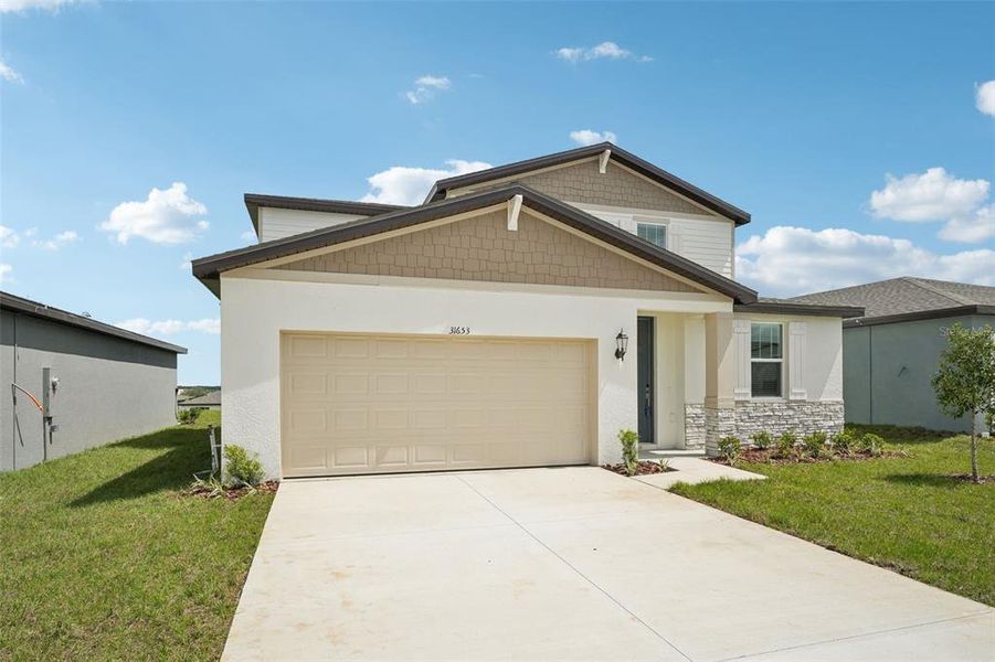 Front exterior of a new home in Benton Hills - Classic Series, Brooksville, FL, highlighting curb appeal (Image 1).