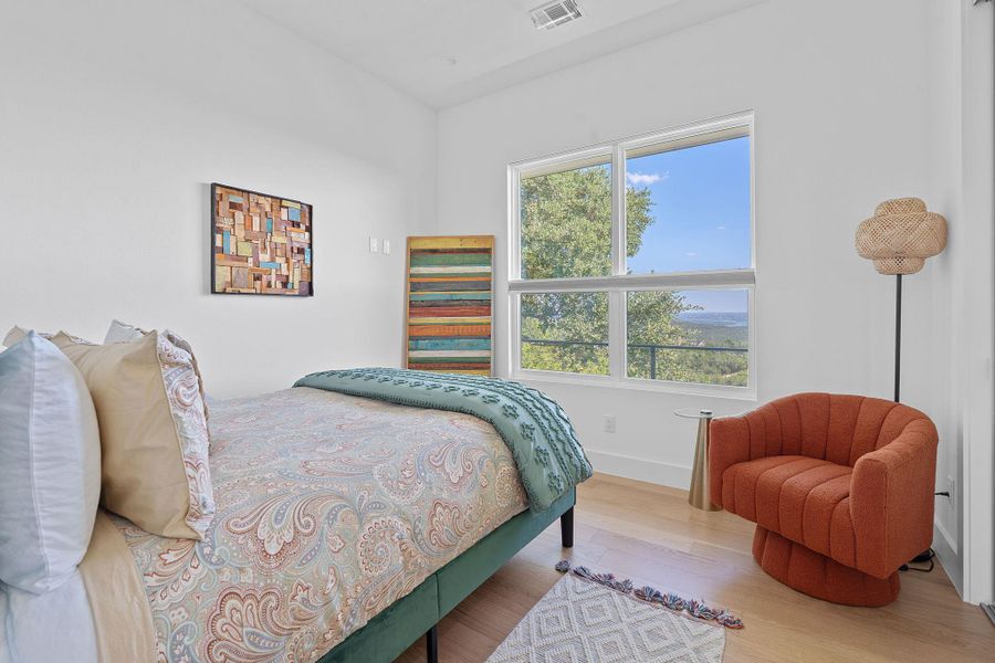 Light-filled secondary bedroom with hill country views Light-filled secondary bedroom with hill country views