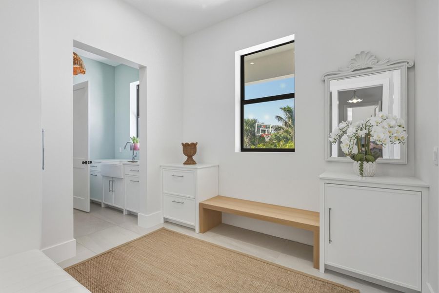 Mudroom with built-ins, shoe closet & access to 3 car garage