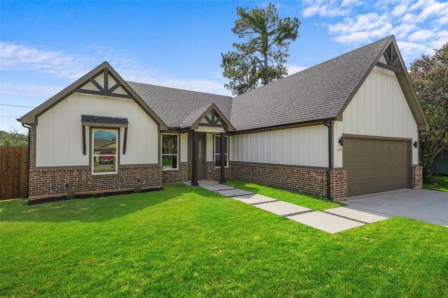 Craftsman-style exterior with board and batten siding and brick accents