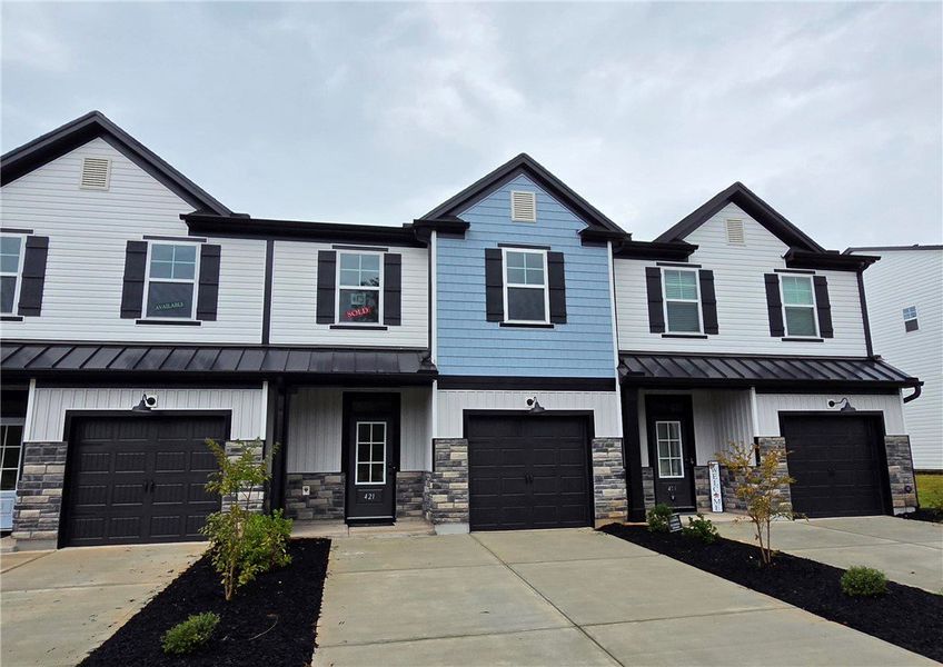 Front exterior of a new home in Meece Townhomes, Easley, SC, highlighting curb appeal (Image 1). Front exterior of a new home in Meece Townhomes, Easley, SC, highlighting curb appeal (Image 1).