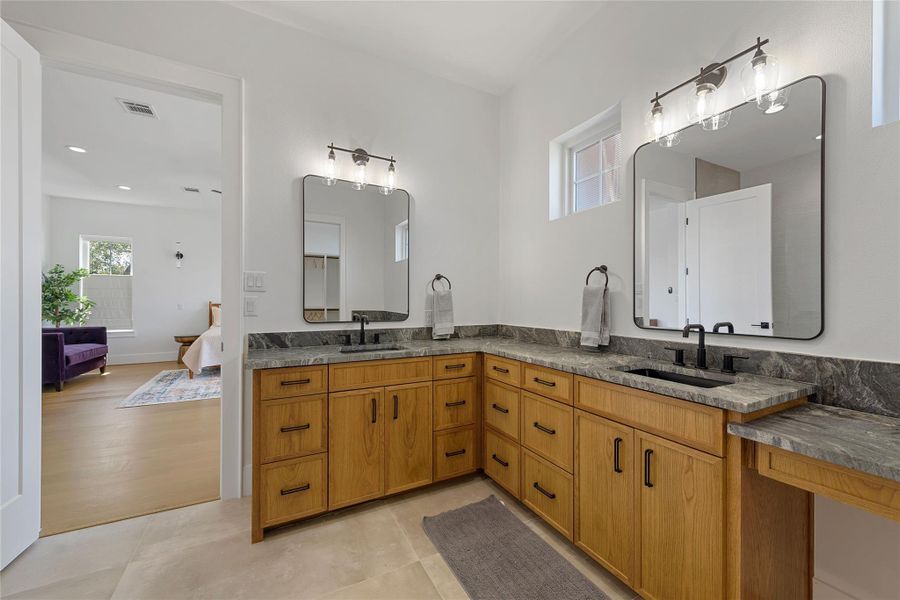 Sophisticated and spa-inspired, this primary bath features a frameless glass shower, gold fixtures, and a sleek vanity with ample storage. A serene retreat designed with both style and function in mind.